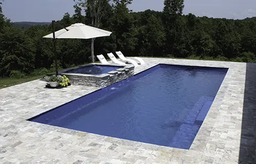 Leisure Pools The Grand rectangular fiberglass composite pool for lounging, installed by Leisure Pools Coastal Mississippi