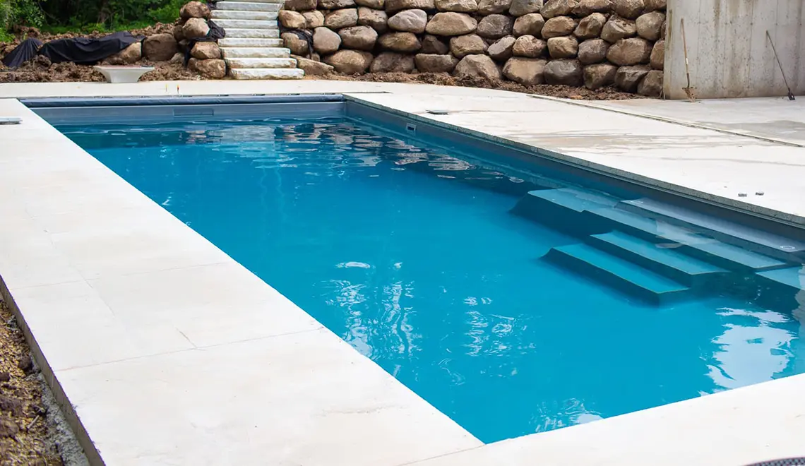 Leisure Pools The Grand rectangular fiberglass pool side view in Coastal Mississippi